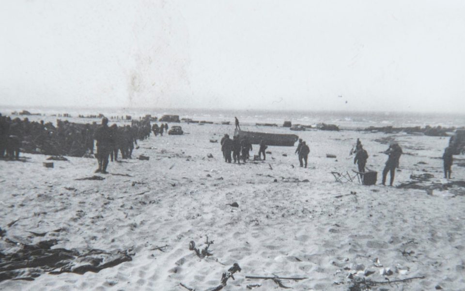  The black and white snaps show German soldiers surveying the wreckage of destroyed ships lying in the surf