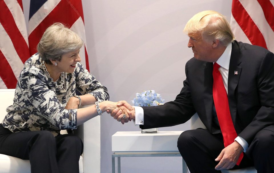  Theresa May and Donald Trump share a handshake at the G20 summit