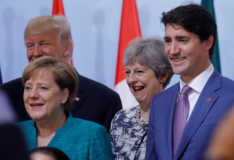  Theresa May poses with Donald Trump, Angela Merkel, and Justin Trudeau