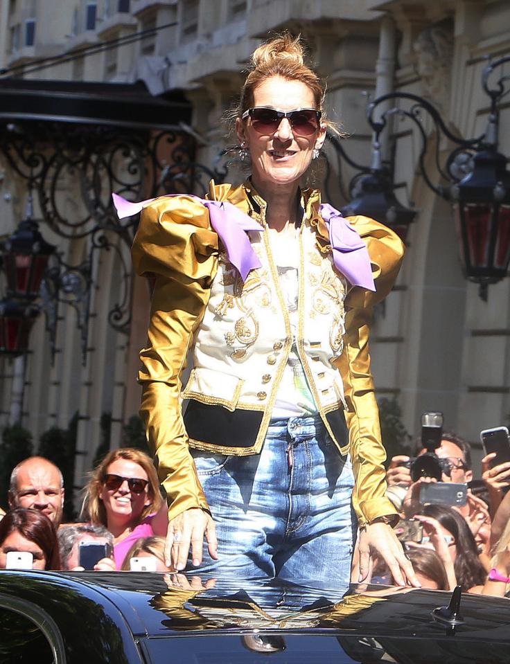  Celine Dion waves to fans as she leaves the Royal Monceau Hotel in Paris