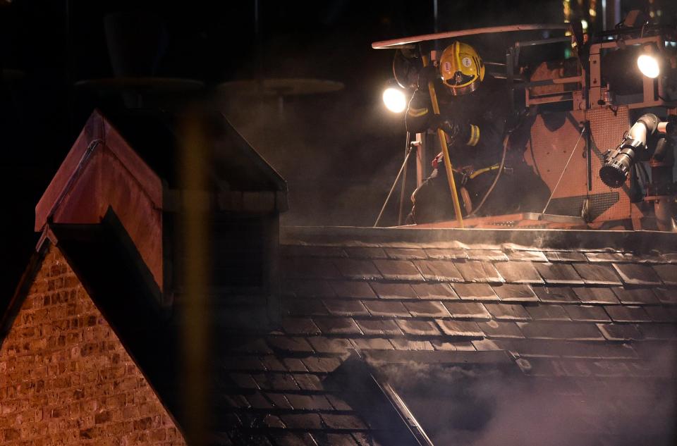  A fireman pictured on a roof top looking down on the blaze