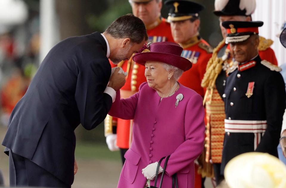  King Felipe VI of Spain kisses the hand of the Queen as she welcomed him and his wife to the UK