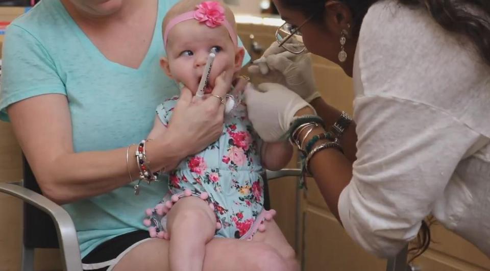  After the markers were placed on the baby's ears, the piercers went to work