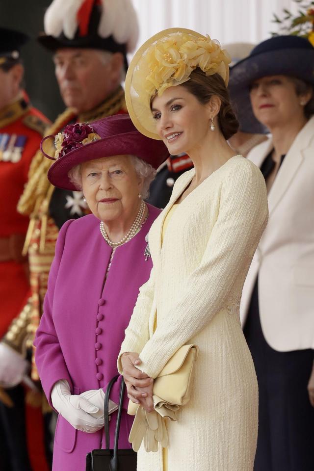  Spain's Queen Letizia stands with Queen Elizabeth as their husbands King Felipe and Prince Philip inspect an honour guard during a ceremonial welcome