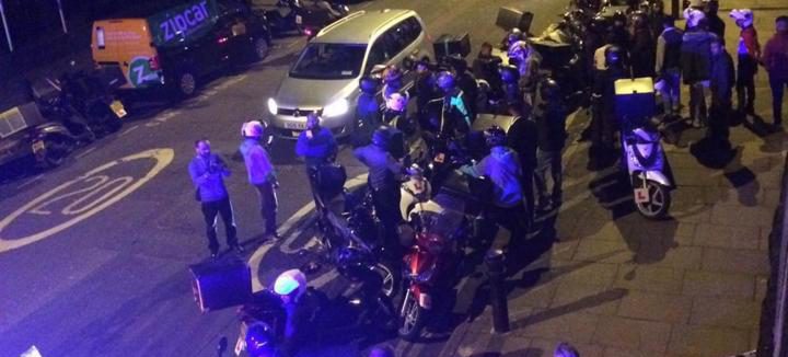  Crowds of delivery food drivers gather in Queensbridge Road, the scene of one of the five acid attacks in north and east London