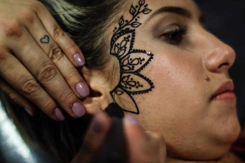  This girl had her face tattooed - but the lack of blood hints it might be a temporary henna design