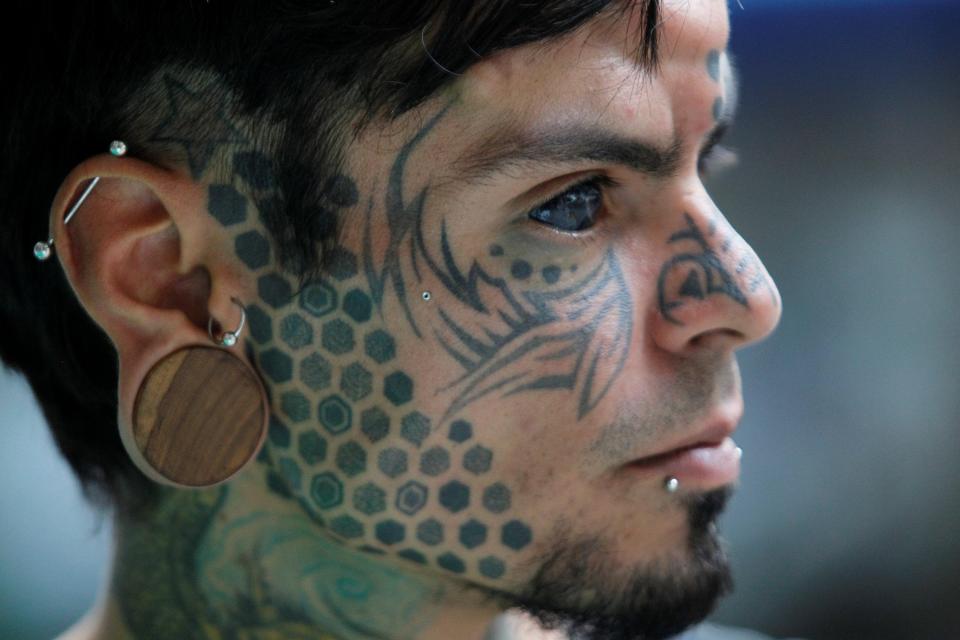  A side view shows how he has had the whites of his eyes inked to give him a soulless look