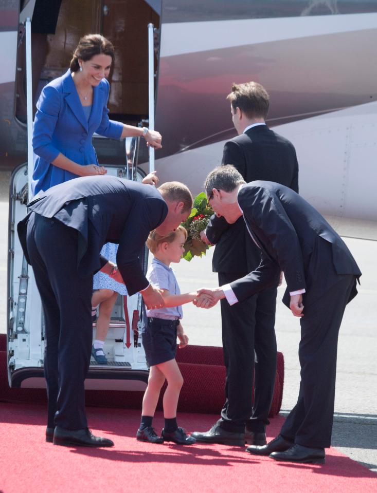  Prince George shaking hands as he arrives in Berlin earlier this week