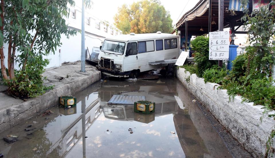  A damaged minivan is seen in Mugla surrounded by floodwater in the aftermath of the earthquake