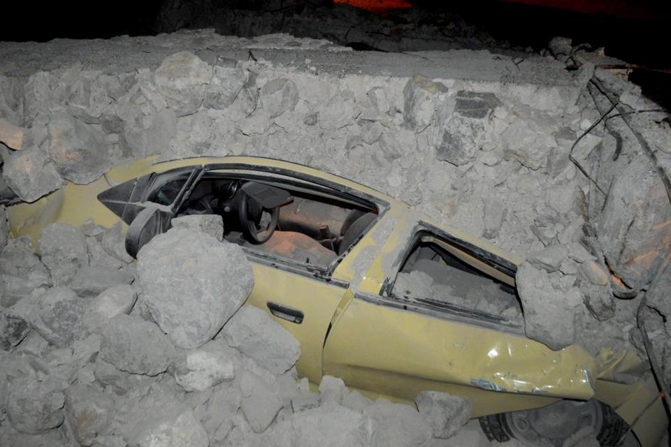  A car is seen covered with rubble on Kos