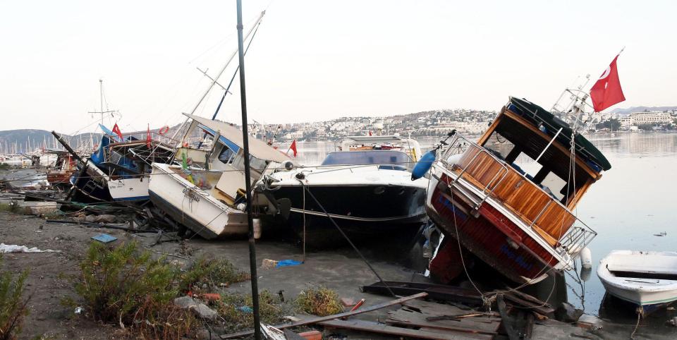  Boats are seen damaged on a beach after the earthquake caused a sea surge in Bodrum, Turkey