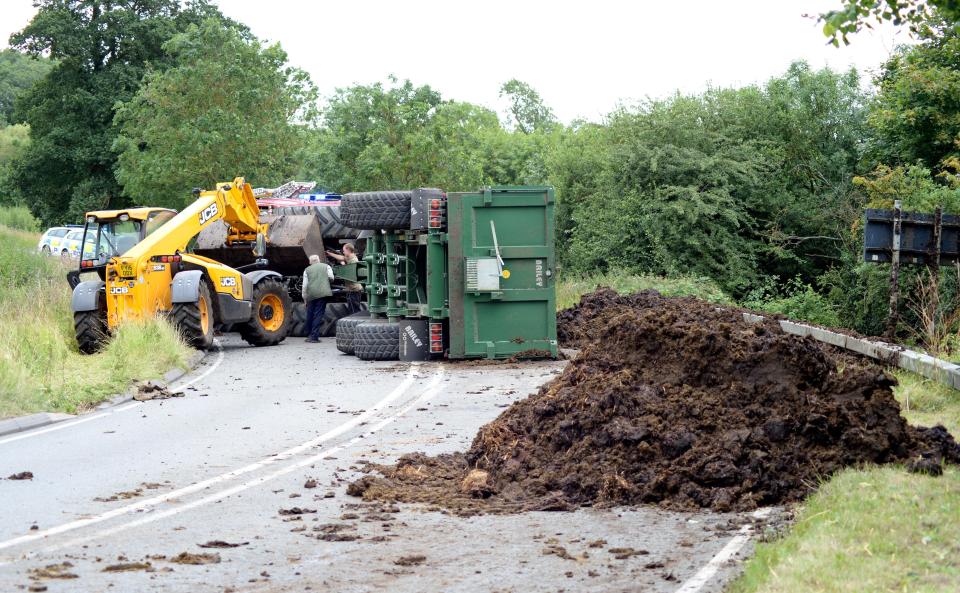  The scene on the A6006, near Melton Mowbray, Leics, after a tractor and trailer overturned sending four tonnes of MANURE across the road yesterday