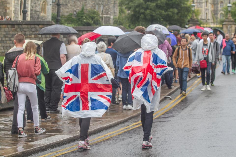  Tourists in Windsor wearing ponchos to shelter from the rain this afternoon