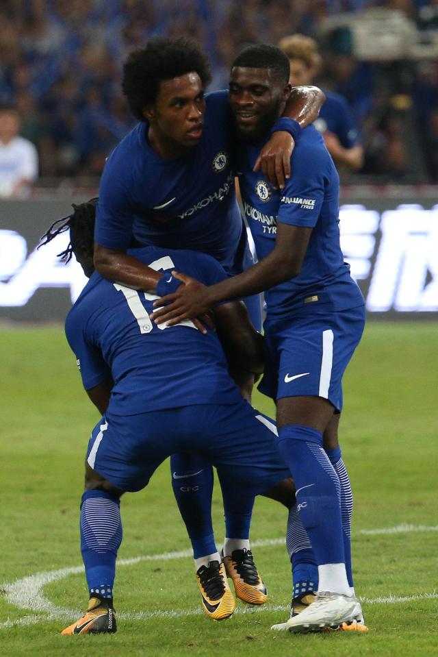  Willian (centre) celebrates after firing Chelsea into the leads with a fine strike