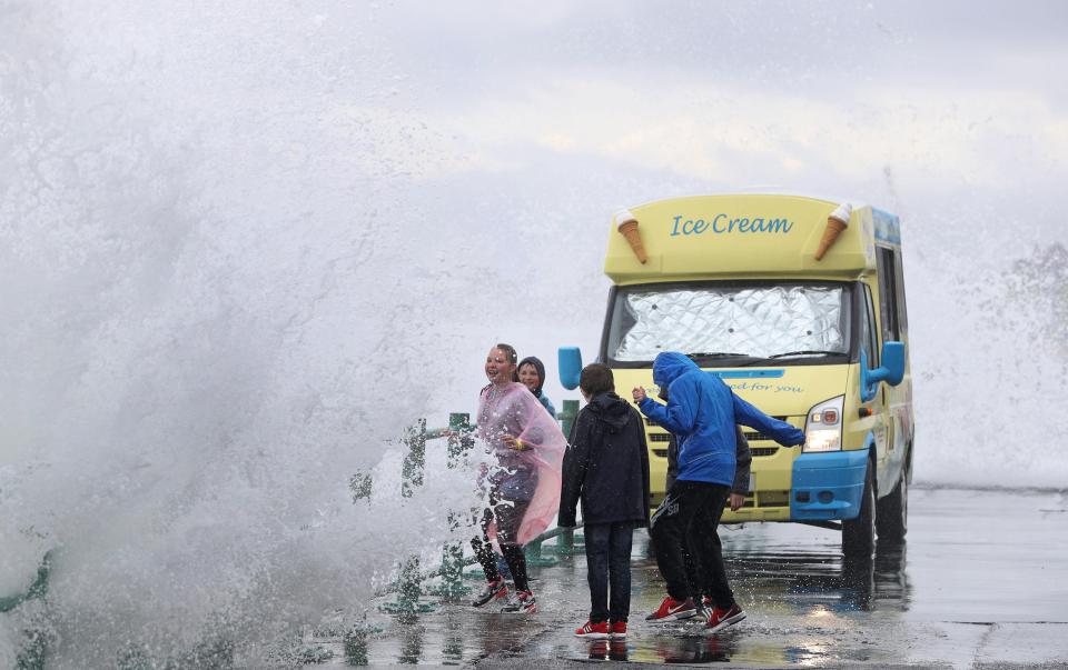  Giant waves swamp people and an ice cream van on the promenade in Sunderland as they wait for a display at the Sunderland Airshow