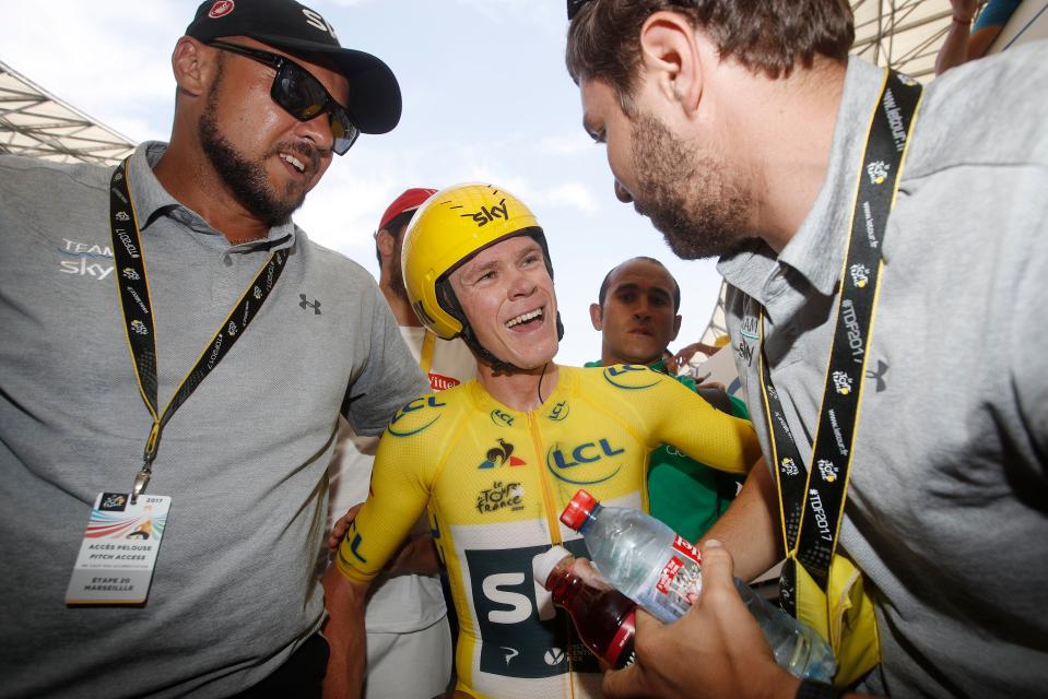  Froome celebrates with his back-up crew after coming through the time trial 54 seconds clear at the top of the Tour de France standings