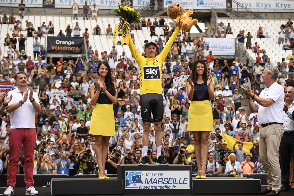  Chris Froome stands on the podium in the Yellow Jersey in the Stade Velodrome