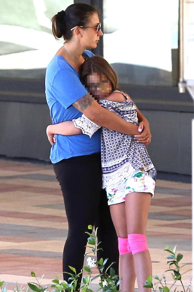  Talinda Ann Bentley grabs one of her twin daughters for a hug during her first trip out after husband Chester's death