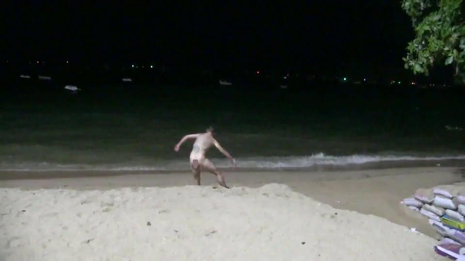 Footage shows the drunk couple stumbling along the beach completely naked