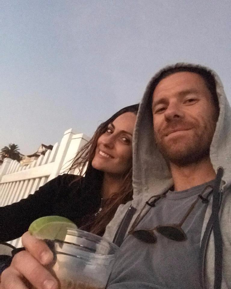 Xabi Alonso and wife Nagore Aranburu share a drink on the beach