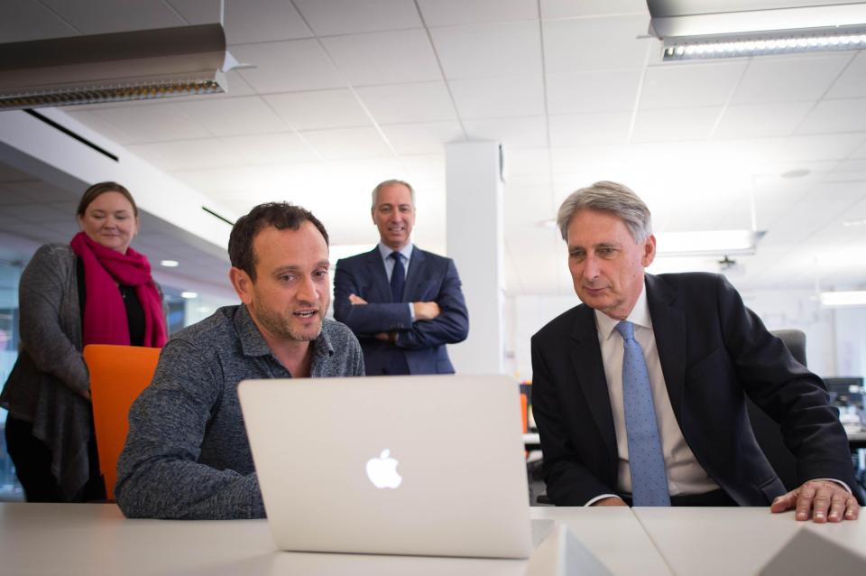  Chancellor Philip Hammond, pictured visiting IBM's offices today, is attempting to boost growth in the run-up to Brexit