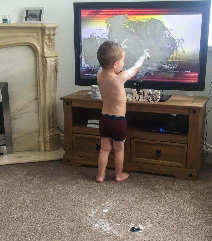  Georgia Joyce, 23, didn't know whether to laugh or cry as she snapped son Charlie, two, smearing Sudocrem all over their brand new TV