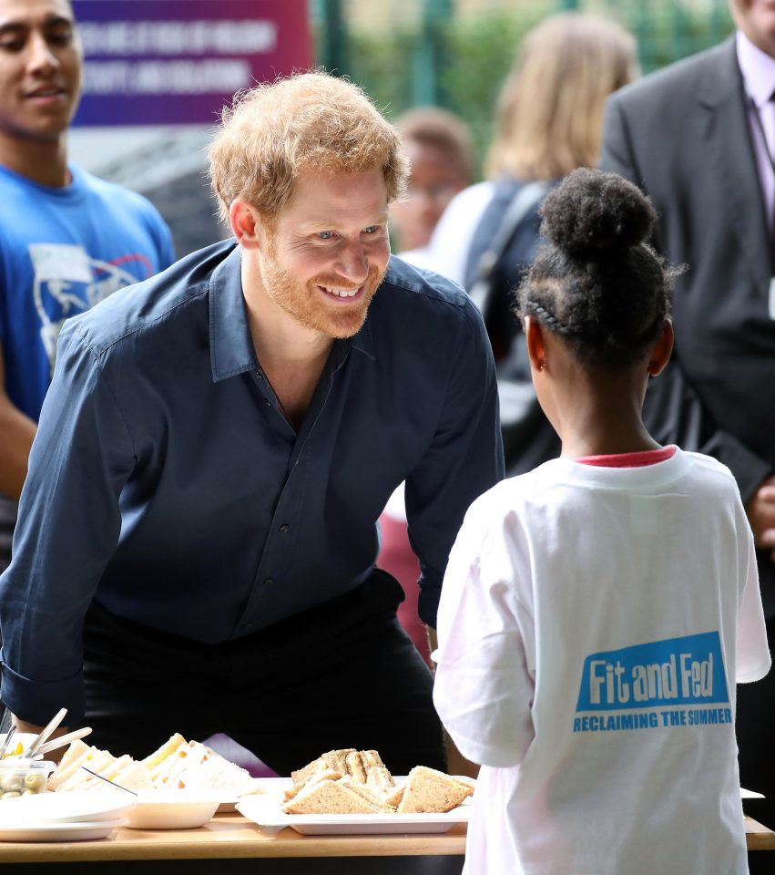  Harry took a turn behind the plates of sandwiches and salads, even getting fingers into the couscous, at Central Park, in Newham