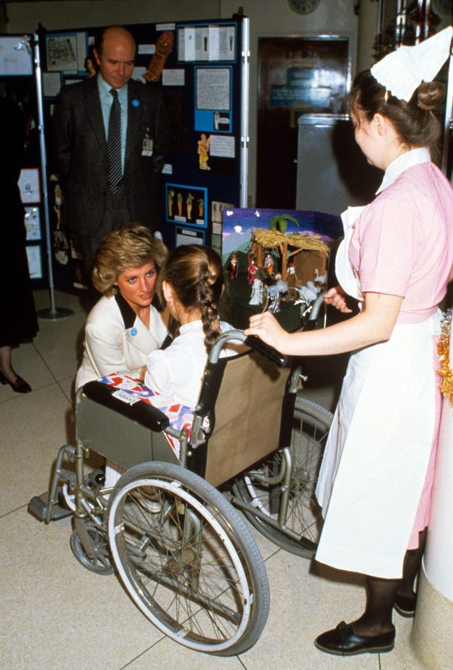  Princess Diana making a Christmas visit to Great Ormond Street Hospital talking to a girl in a wheelchair