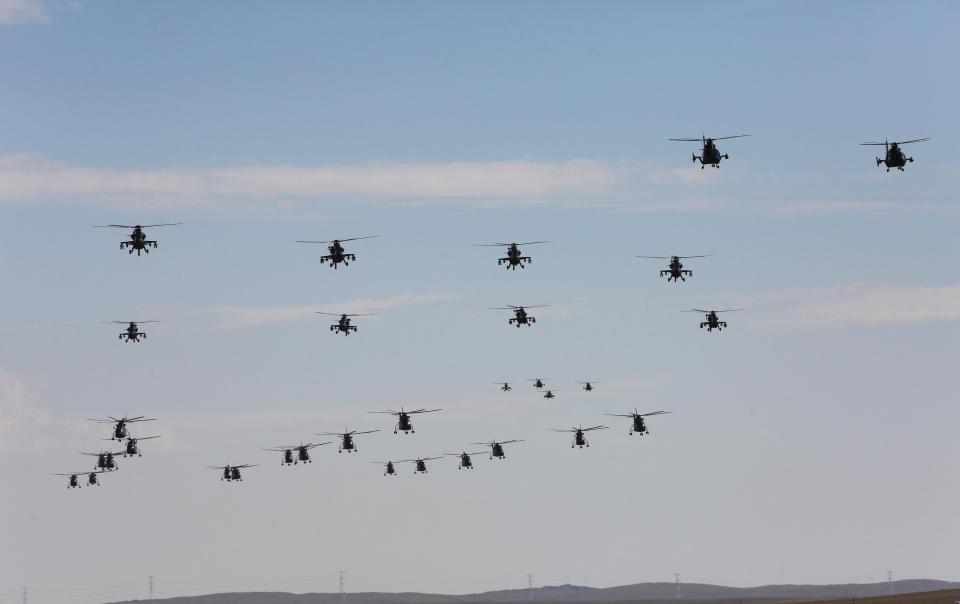  Helicopter fleets paraded overhead as the army marched below