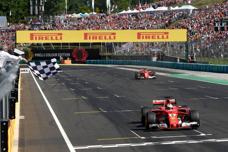  Sebastian Vettel crosses the finish line as he raced to victory at the Hungarian Grand Prix