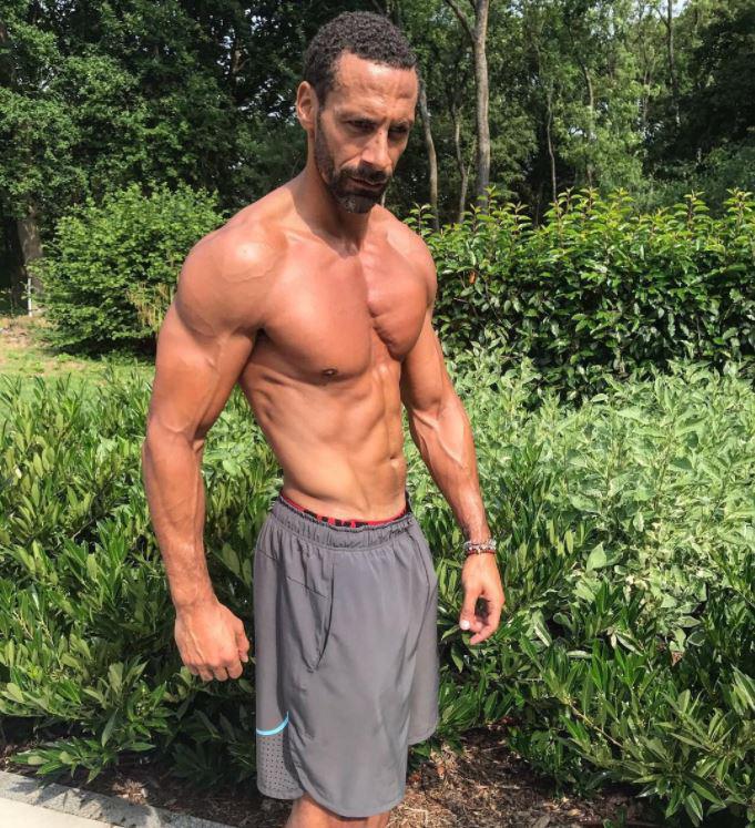  Rio Ferdinand takes off his shirt to reveal his buff torso