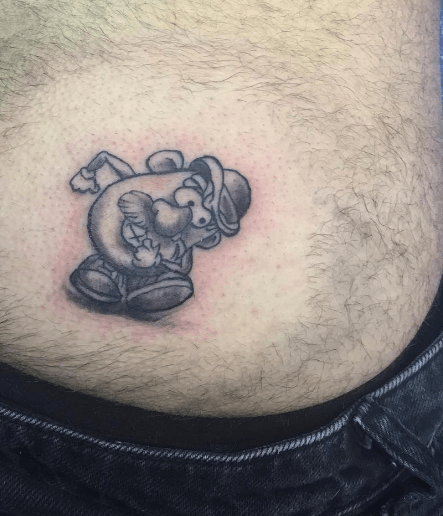  A Magaluf holidaymaker shows off his comical Mr Potato Head design - that he's had inked on his BUM