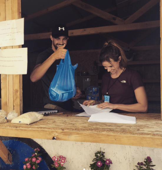 Camilla Thurlow and Jamie Jewitt are busy working in a refugee camp