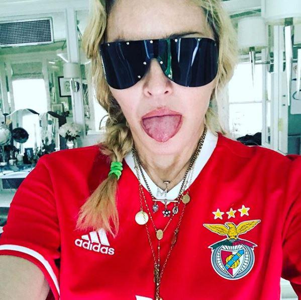 Madonna, wearing a Benfica top, has moved to Lisbon for her son's career