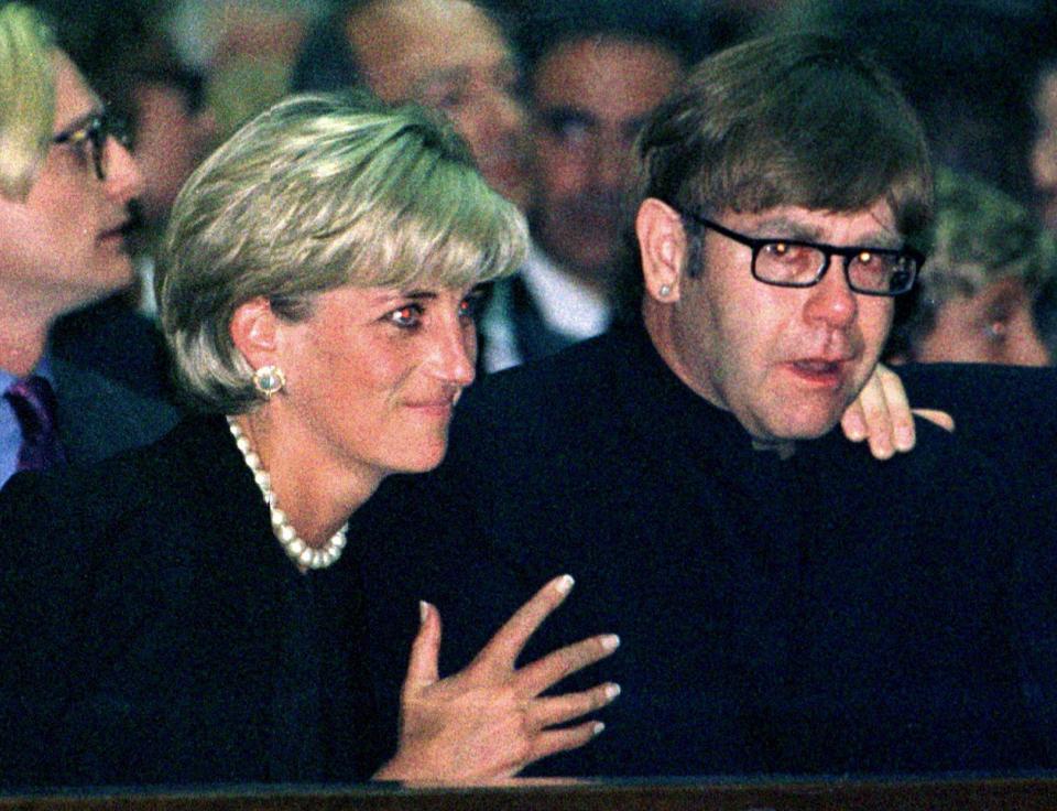  Princess Diana comforts Elton at the funeral for their friend and fashion designer Gianni Versace