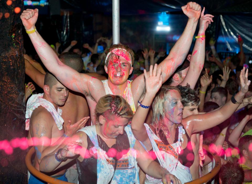 Revellers go wild at a neon paint party at Disco Orange, Sunny Beach, Bulgaria