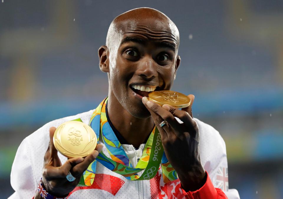 Farah shows his medals after winning the 2016 Olympic 5,000m to complete the long distance double in Rio