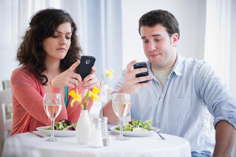  Put the phones down... Brits can't resist texting or taking photos during mealtimes