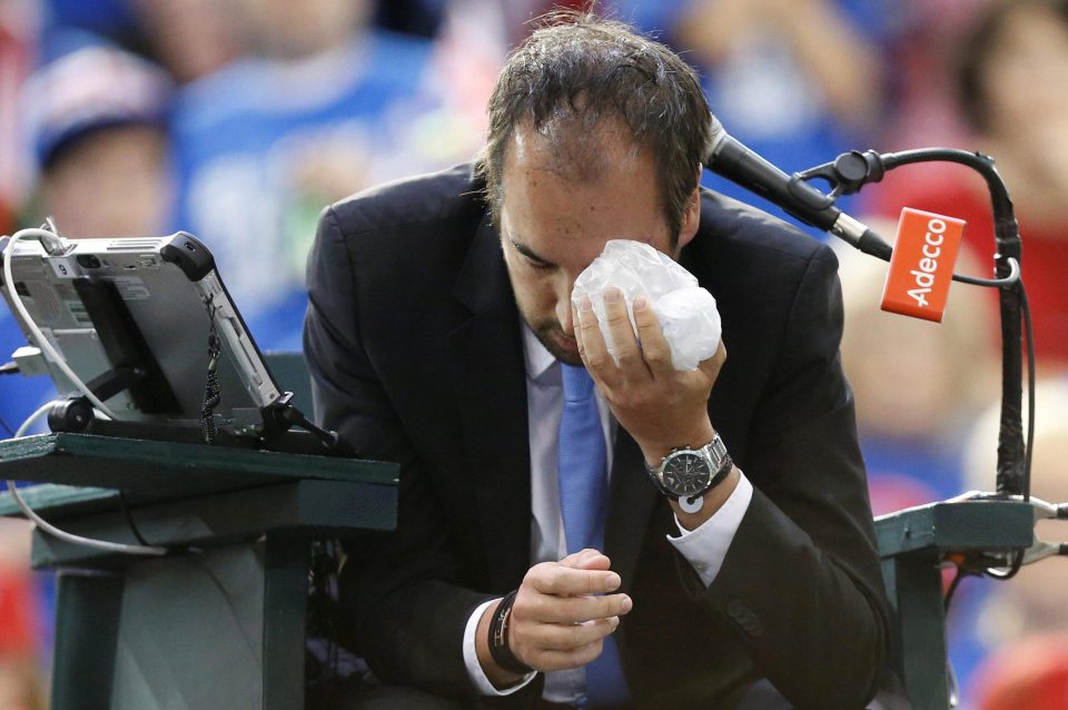  Arnaud Gabas uses ice after being struck by a ball hit by Denis Shapovalov