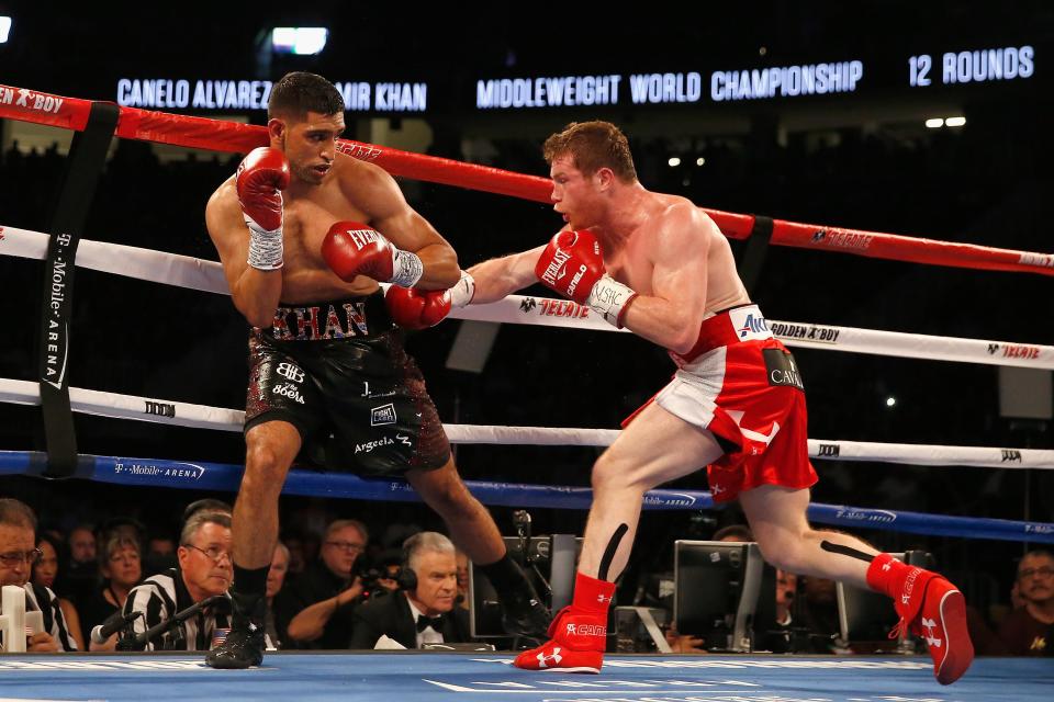 Canelo Alvarez throws a right at Amir Khan during the WBC middleweight title fight at T-Mobile Arena on May 7, 2016 in Las Vegas, Nevada. The fight reportedly saw Khan earn a whopping £9million