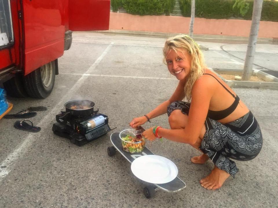  Kate cooks up some dinner using a skateboard as a kitchen worktop outside the van