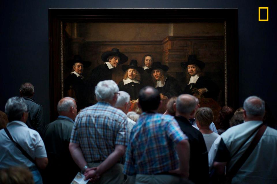  A crowd of spectators stands in front of Rembrandt’s masterpiece, Syndics of the Drapers’ Guild, at Rijksmuseum in Amsterdam - where the people in the painting also appear to be curiously watching the visitors