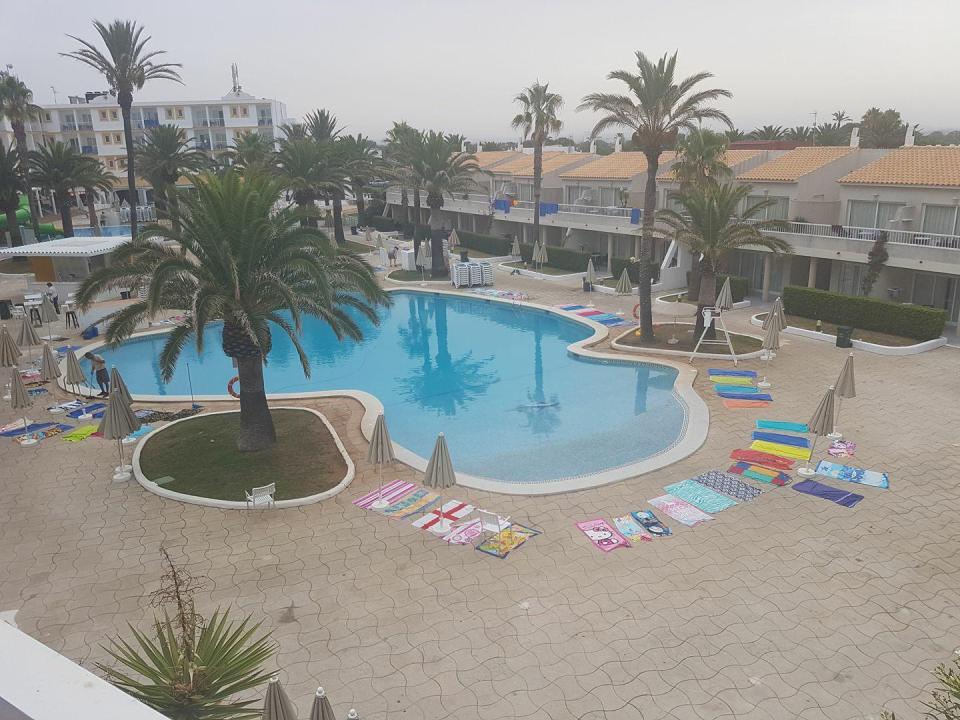  Guests at the Sunconnect Los Delfines try to reserve spots next to the pool with towels before staff have even put out sun loungers