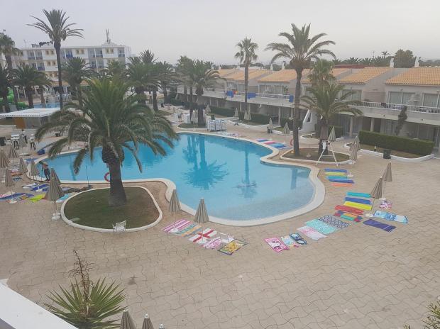 Guests at the Sunconnect Los Delfines try to reserve spots next to the pool with towels before staff have even put out sun loungers