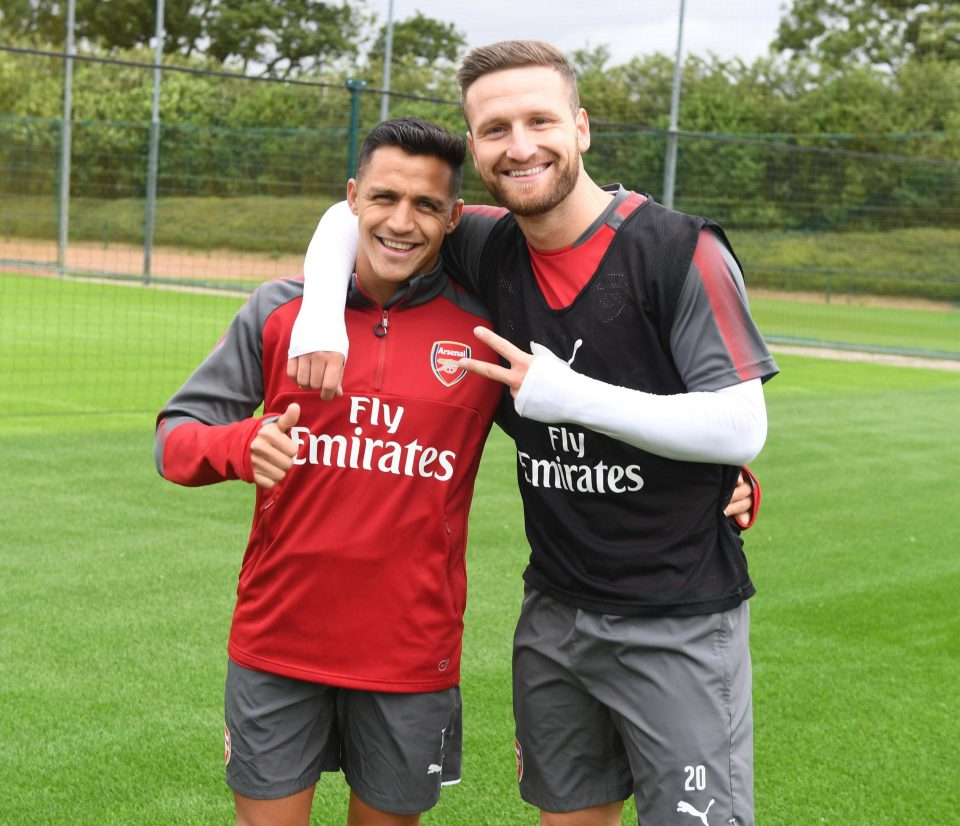  Shkodran Mustafi looked happy to have Alexis Sanchez back in training