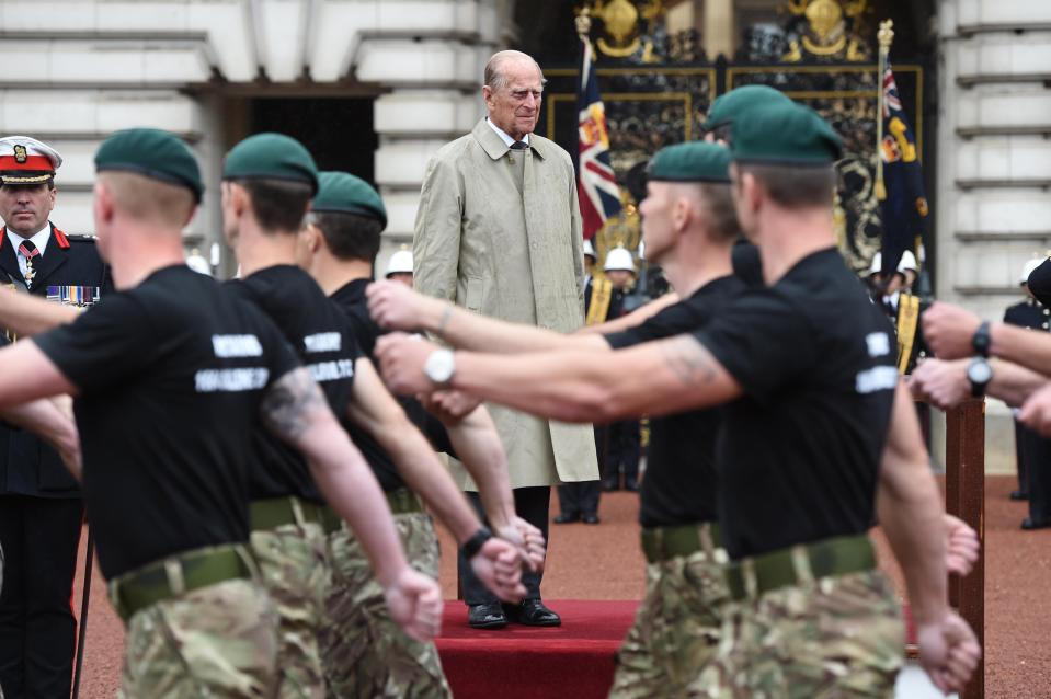  Prince Philip looks on as Royal Marines march in front of him after completing impressive trek for charity