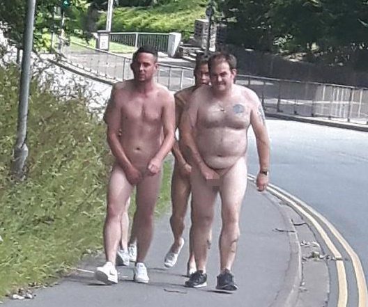  Four men do the walk of shame wearing nothing but their trainers toward a Cumbria town