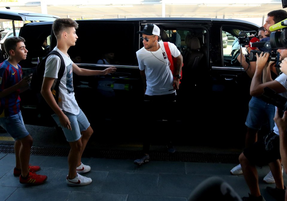 A fan pleads with Neymar as he heads for the airport to complete his transfer to Paris Saint-Germain