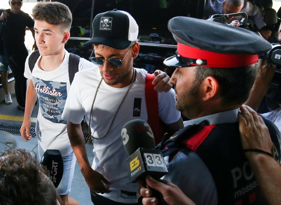 A Barcelona fan put his arm around Neymar as another asked for his signature as he headed to Paris to complete a world record move