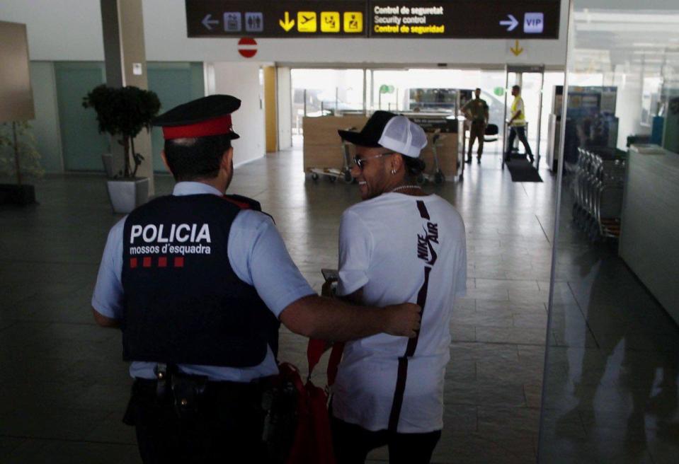 Neymar was escorted by a policeman to his gate to catch his flight to Paris